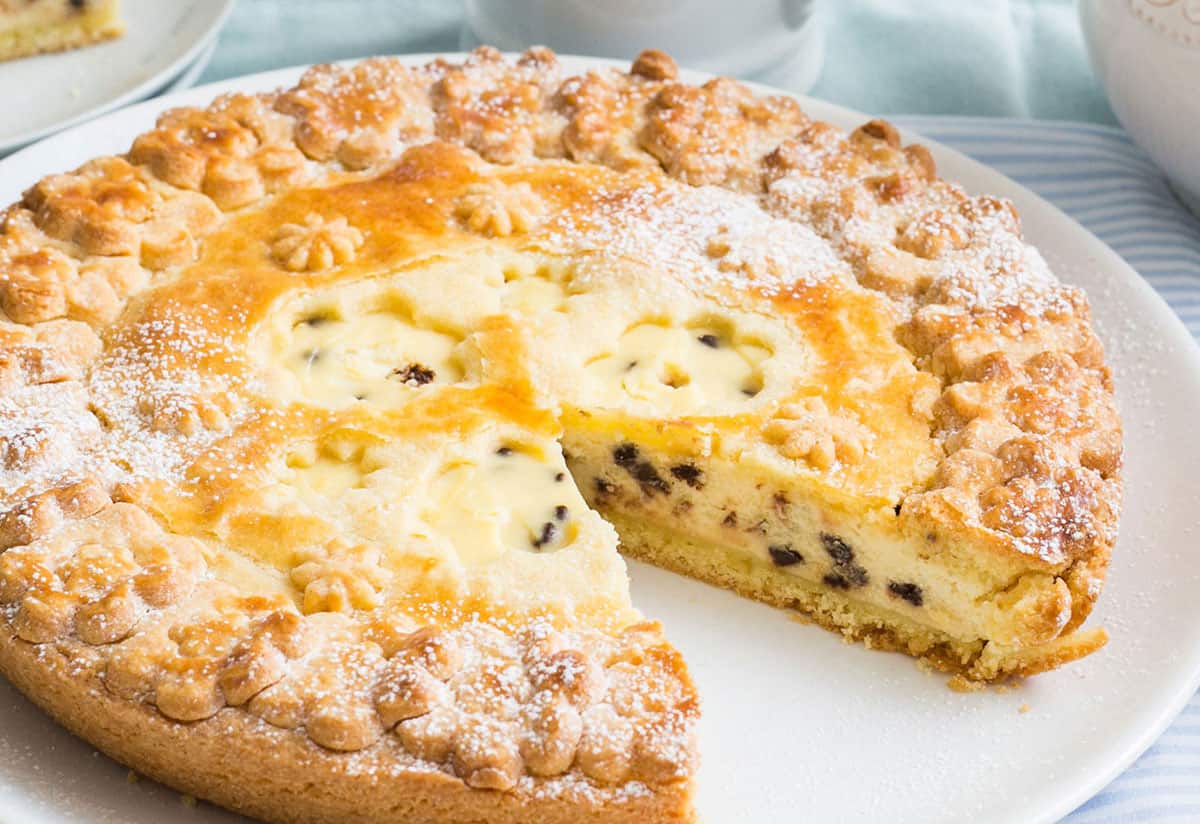 Ricotta pie with a slice missing.