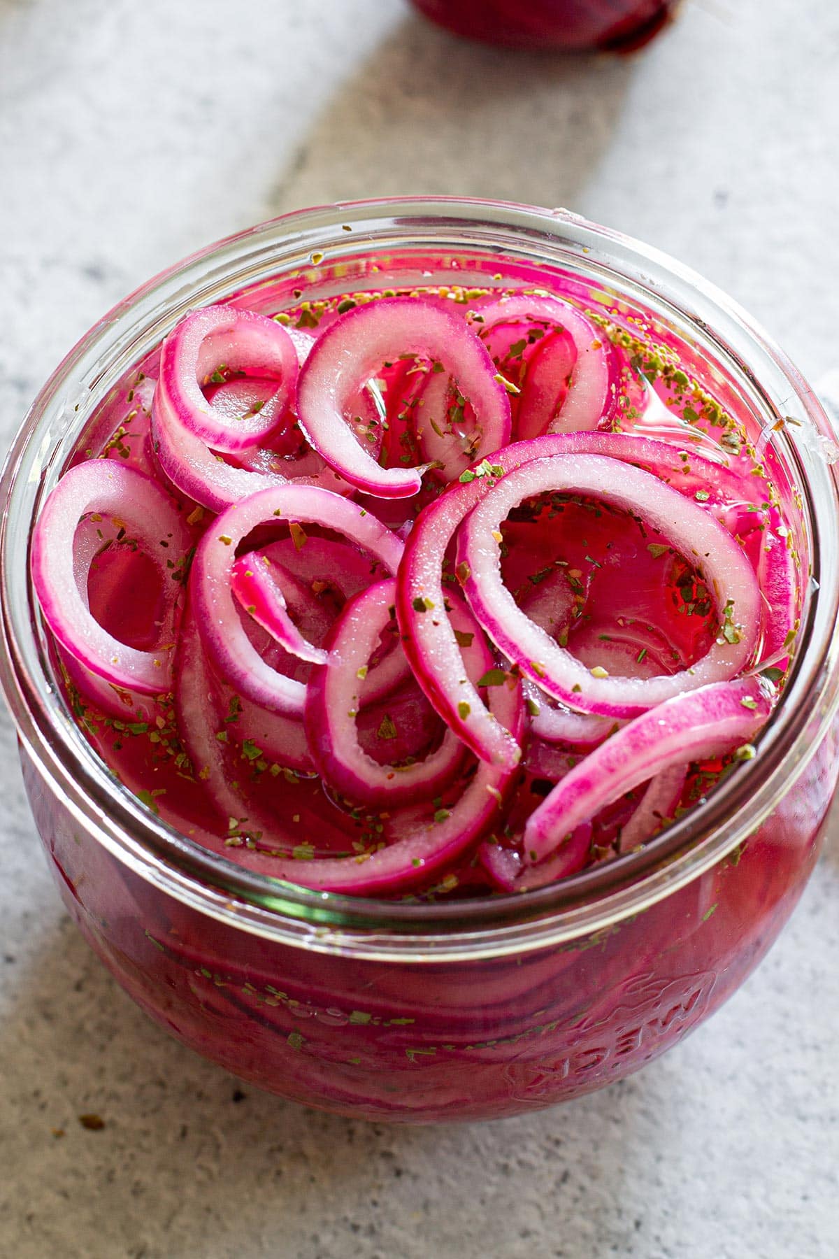 Close-up of Mexican red pickled onions, also known as cebollas curtidas en vinagre.