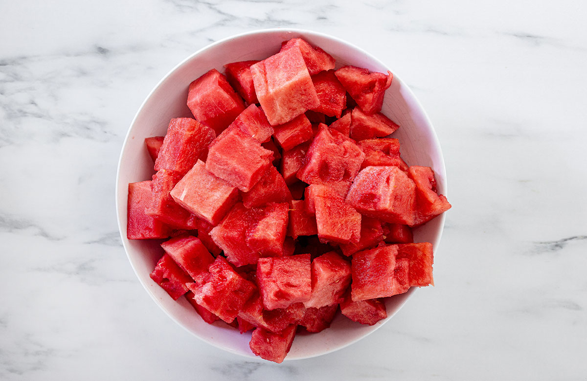Watermelon cut into cubes in a plate.
