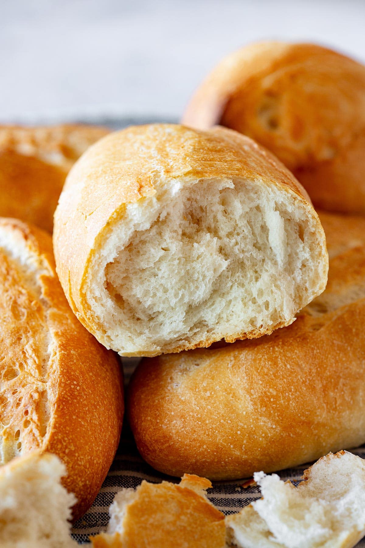 A bolillo roll opened to see its soft crumb.