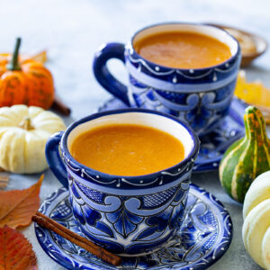 Two clay cups with Mexican Atole de Calabaza, aka pumpkin atole.