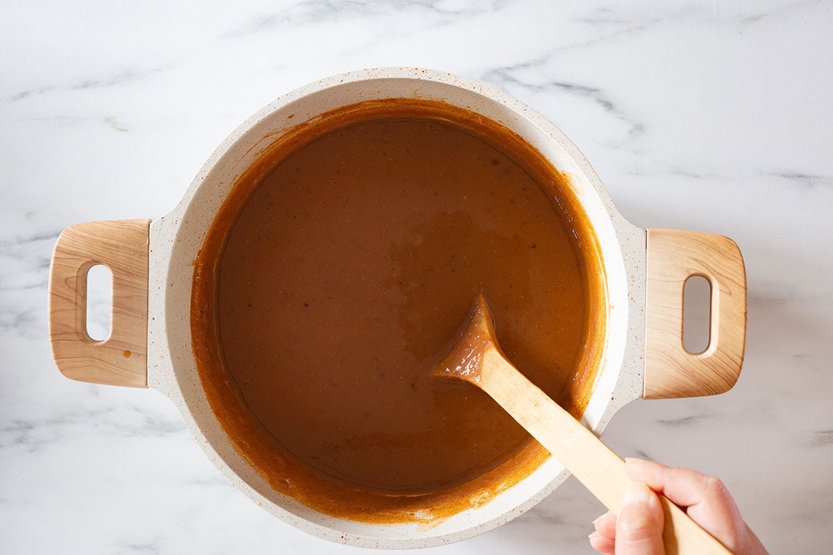 Fully blended and cooked sopa de frijoles in a soup pot.