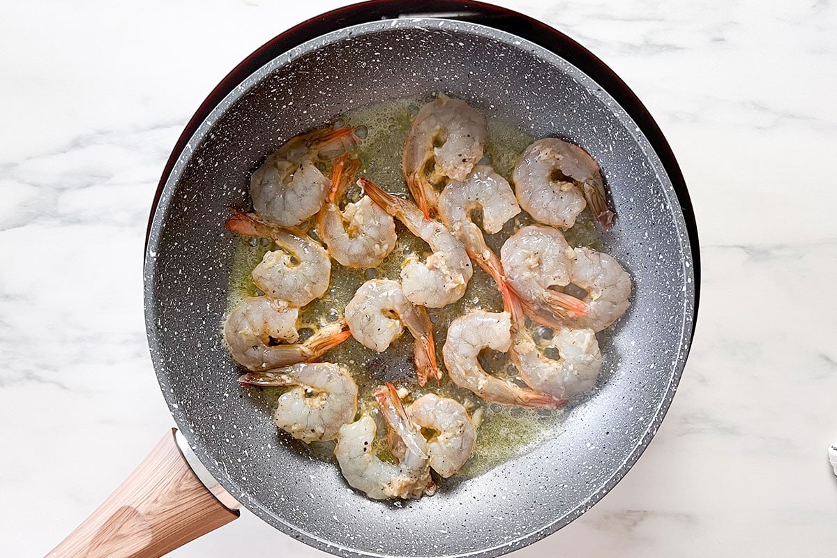 Shrimp sautéed on a pan.